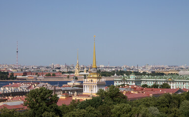 Fototapeta na wymiar panoramic top view of the historical center of the city and the high spire of the Admiralty on a sunny summer day and a space for copying in Saint-Petersburg