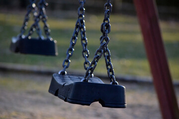 photos of empty swings in the neighborhood park