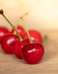 Group of Red Cherries on Wood Background