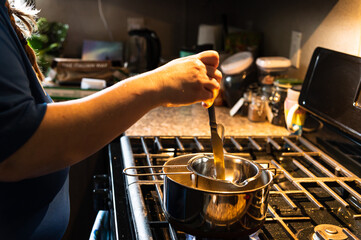 Woman Stirring Double Boiler Contents 