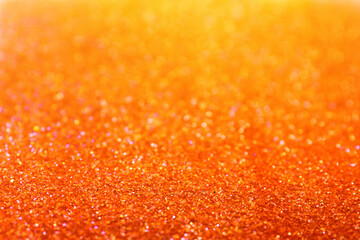 Shiny orange glitter as background. Bokeh effect