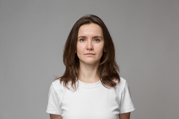Portrait of a young woman in a white T-shirt. Naturalness.