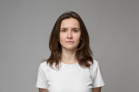 Portrait of a young woman in a white T-shirt. Naturalness.
