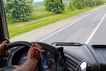 The hands of a professional driver on the steering wheel. Background with copy space for text