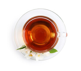 Glass cup of aromatic jasmine tea and fresh flowers on white background, top view
