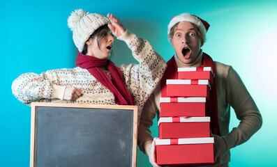 two people with blackboard. Christmas couple. Sale. Emotion face. Photo. Happiness. 