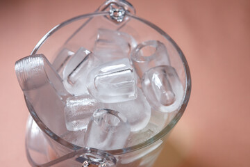 Transparent glass ice bucket for cooling drinks.