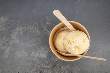 Top view Cup of scoop soy based Umami Ice-cream on metal background in Berlin, Germany. 