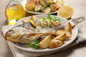 Tasty homemade roasted crucian carp served on wooden table. River fish