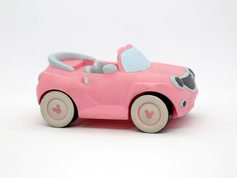 Minnie Mouse pink car. Toy. Cartoon character from Walt Disney Pictures Studios. Minnie is Mickey Mouse's girlfriend. Isolated white. Plastic toys for childrens.  Vehicle. Toy car. 