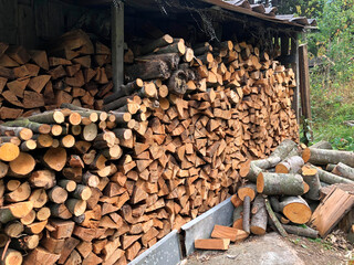 They put the firewood in a woodpile. Chopped firewood.