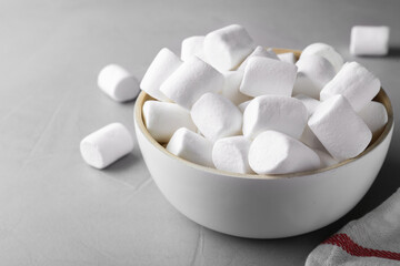 Fototapeta na wymiar Delicious puffy marshmallows on grey table, closeup