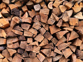 Beautiful brown background a lot of firewood close-up.