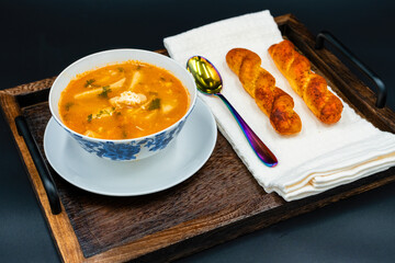 A bowl of soup sitting on top of a wooden table