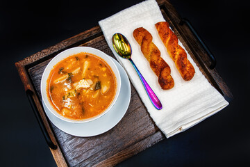 A bowl of soup sitting on top of a wooden table
