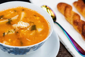 A bowl of soup sitting on top of a wooden table