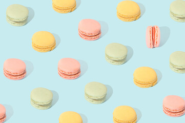 Obraz premium Macarons in different pastel colors arranged in a pattern. Sweet food cake concept