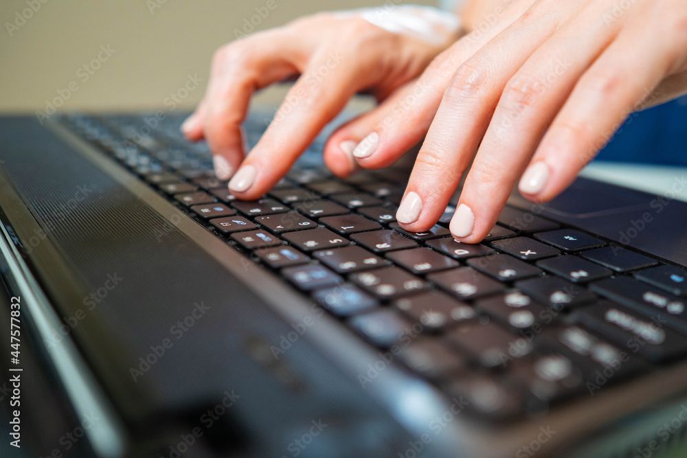 Poster man is typing on keyboard. female hands on laptop. hands on a black keyboard close up. man gaining t