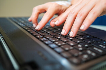 Man is typing on keyboard. Female hands on laptop. Hands on a black keyboard close up. Man gaining text using laptop. Typing on black keypad. Concept - learning fast typing on keyboard.
