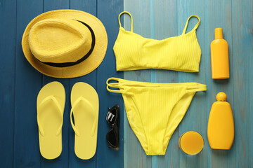 Flat lay composition with beach objects on blue wooden background