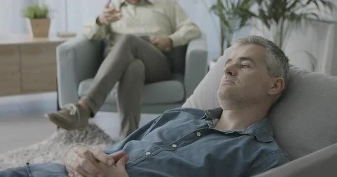 Patient lying on the couch and listening to his therapist