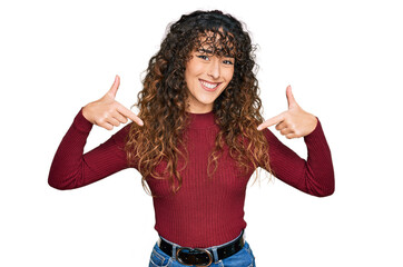 Young hispanic girl wearing casual clothes looking confident with smile on face, pointing oneself...