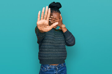 Young african american woman wearing casual clothes covering eyes with hands and doing stop gesture with sad and fear expression. embarrassed and negative concept.