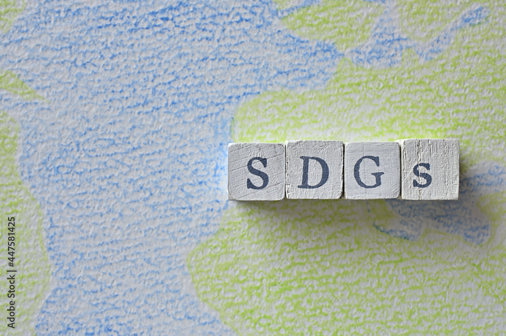 Aufkleber there is a cube stamped with the letters of the sdgs on top of a sketchbook with a picture of the ea