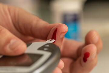 Blood sugar measuring: A person collecting a blood drop to get blood glucose test results