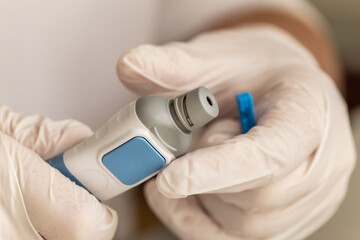 Blood sugar measuring: A person stings a finger to get blood for blood glucose analysis