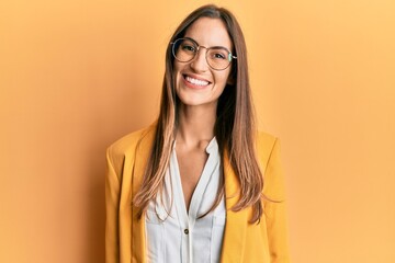 Young beautiful woman wearing business style and glasses with a happy and cool smile on face. lucky person.
