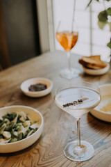 A table topped with plates of food on a plate and cocktail