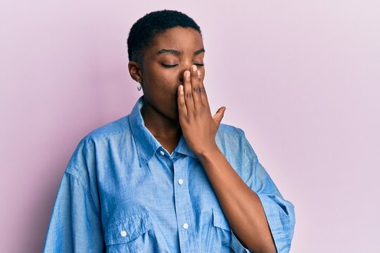 Young african american woman wearing casual clothes bored yawning tired covering mouth with hand. restless and sleepiness.