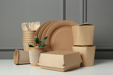 Disposable eco friendly products on white wooden table