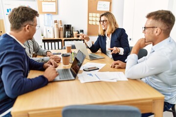 Group of middle age business workers working at the office.