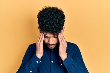 Young arab man with beard wearing casual shirt with hand on head for pain in head because stress. suffering migraine.