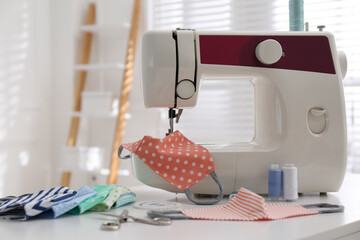 Sewing machine with cloth mask on table indoors
