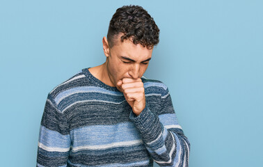 Hispanic young man wearing casual clothes feeling unwell and coughing as symptom for cold or bronchitis. health care concept.