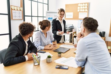 Group of young business workers listening boss speech during meeting at the office.