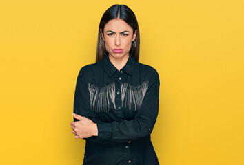 Young hispanic woman wearing casual clothes skeptic and nervous, disapproving expression on face...