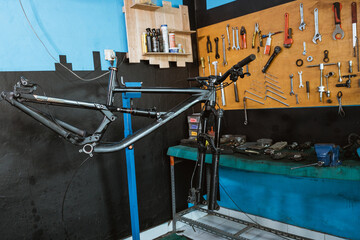 bicycle frame without hanging wheels will be repaired and installed in parts in the workshop