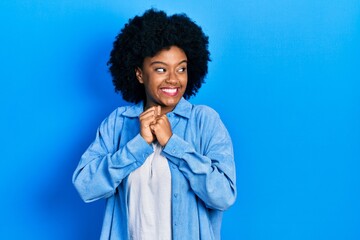 Fototapeta na wymiar Young african american woman wearing casual clothes laughing nervous and excited with hands on chin looking to the side