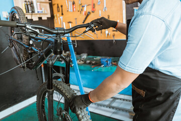 mechanical hands with gloves try the brake lever and hold the wheel to find out if the brakes are...