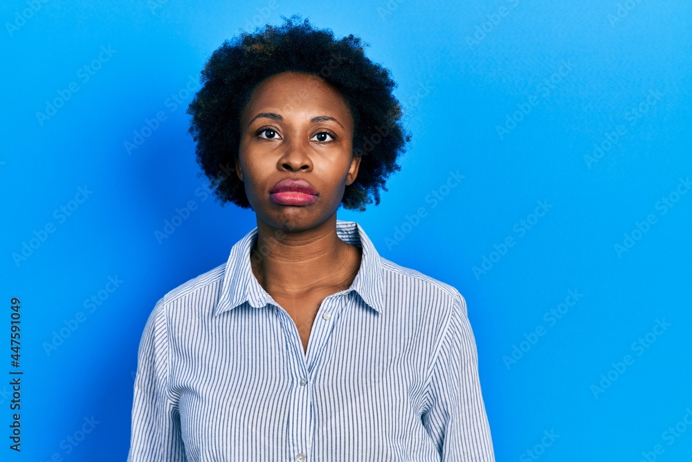 Poster Young african american woman wearing casual clothes relaxed with serious expression on face. simple and natural looking at the camera.