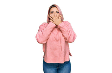 Hispanic woman with pink hair wearing casual winter sweater shocked covering mouth with hands for mistake. secret concept.