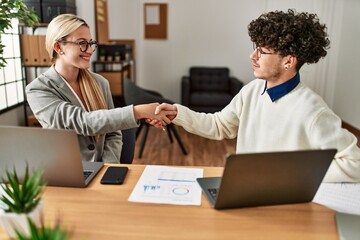 Obraz premium Two business executives shaking hands at the office.