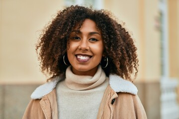 Young african american woman smiling happy standing at the city.