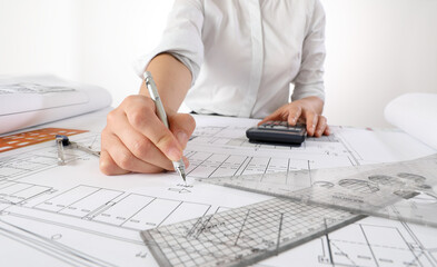 Architect Drawing Blueprint At Desk In Office