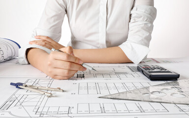 Architect Drawing Blueprint At Desk In Office