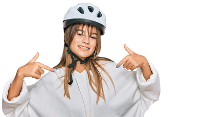 Teenager caucasian girl wearing bike helmet looking confident with smile on face, pointing oneself with fingers proud and happy.